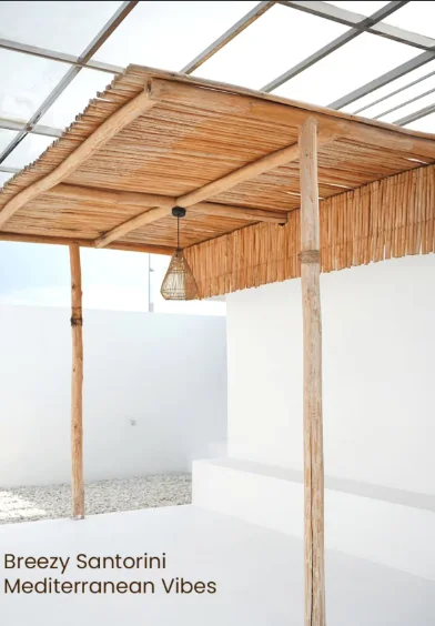 Whitewashed veranda with a bamboo pergola and a rattan lamp