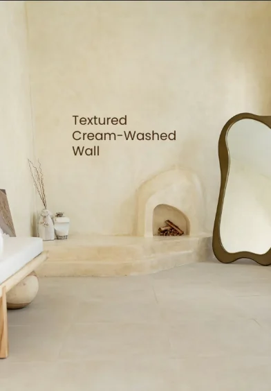 Textured cream wall with a sculptural fireplace and a curved mirror