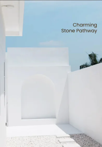 White stone pathway leading to an arch under blue sky